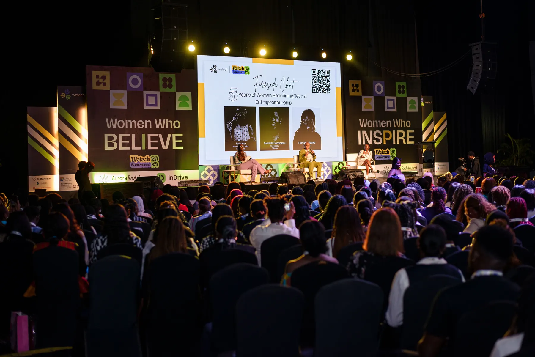 Women Who Believe / Women Who Inspire — the panels either side of the stage.