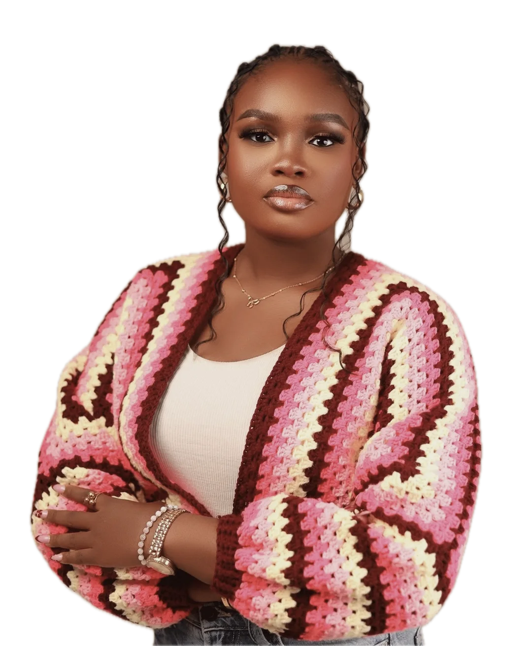 Adenike Adedokun, arms folded, in a hand-crocheted striped cardigan
